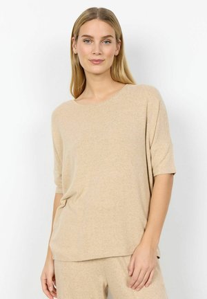 Beige knitted top with a round neckline and short sleeves, featuring a relaxed fit and subtle texture. The fabric is soft and lightweight.