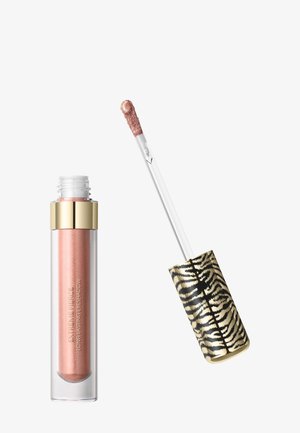 Tube d'ombre à paupières liquide or rose avec bouchon doré et applicateur en baguette à motif zèbre, ouvert avec applicateur levé et produit visible.