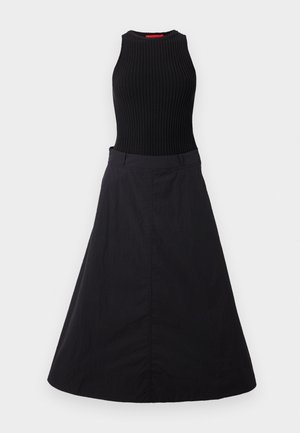 Black dress featuring a ribbed sleeveless bodice and a flowing skirt. The fabric has a smooth texture with a subtle sheen.