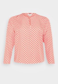 Red long-sleeve shirt featuring a white scallop pattern, with a button closure at the neck and a soft, textured fabric.