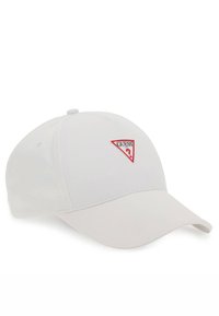 White baseball cap made of cotton, featuring a red triangular "GUESS" logo on the front, with a curved visor and adjustable back strap.