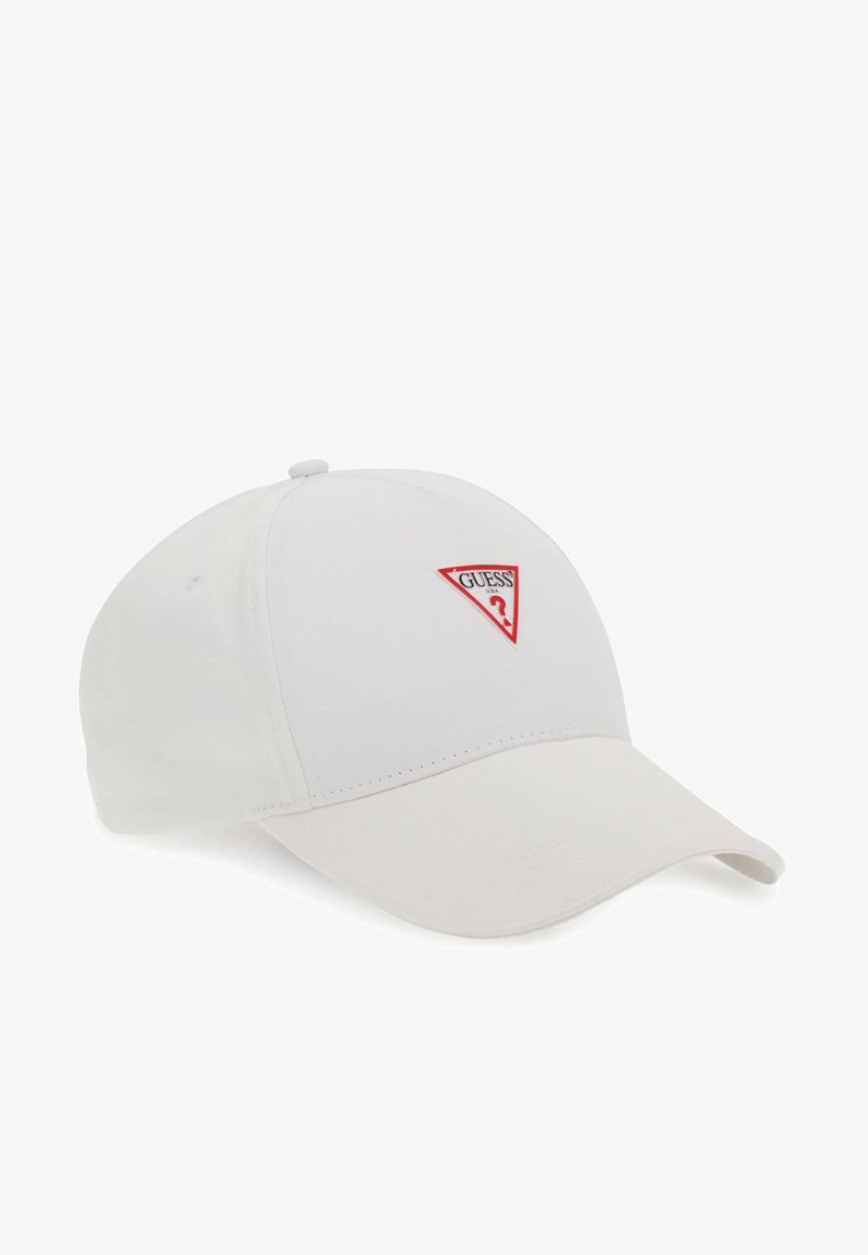 White baseball cap made of cotton, featuring a red triangular "GUESS" logo on the front, with a curved visor and adjustable back strap.