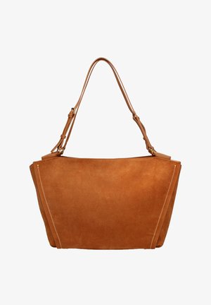 Lichtbruine suède handtas met brede trapeziumvorm, verstelbare schouderriem en witte stikaccenten aan de zijkanten.