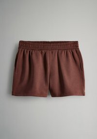 Pantaloni sportivi marroni con vita elasticizzata, due tasche laterali e un tessuto liscio e strutturato, adatto per un abbigliamento casual.