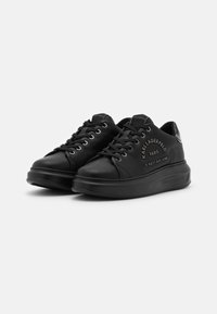 Black leather sneakers with a smooth texture, round toe, front lacing, embossed logo details, and a thick, solid black rubber sole.