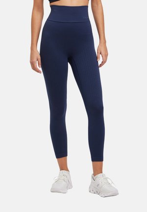 Marineblaue High-Waist-Leggings mit einem strukturierten Muster. Hergestellt aus einem dehnbaren Material, haben sie ein figurbetontes Design und eine glatte Oberfläche.