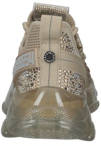 Basket beige vue de derrière avec semelle transparente, ornements en strass, languette en tissu et une section marquée "8564" sur le côté.