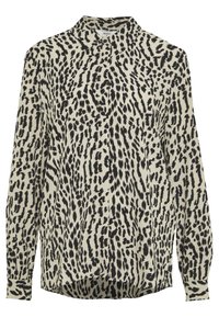 Blusa de manga larga beige con estampado abstracto de leopardo negro, puños abotonados y cuello con solapa.