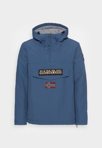 Blue windbreaker jacket with a hood, featuring a front pocket, logo patch, and Norwegian flag detail. Smooth material with a matte finish.