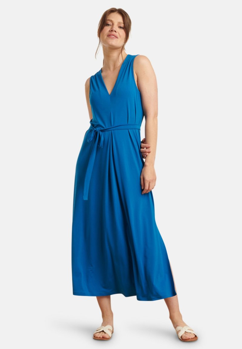 Blue sleeveless dress with a V-neck, belted waist, and flowing long skirt. Made of smooth fabric with a soft texture.