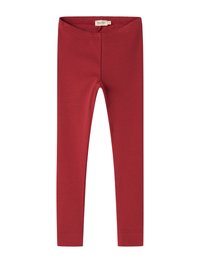 Punased ribatud retuusid elastse vöökoha ja pehme tekstuuriga. Sobiv kuju ja täispikk disain. Ilma nähtavate mustrite või riistvarade detailideta.