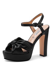 Sandale plateforme noire à talon haut avec bride avant nouée et bride de cheville réglable avec boucle, doublure intérieure beige et talon bloc solide.
