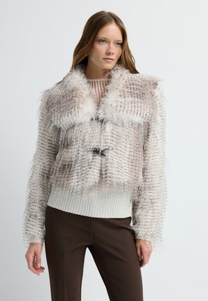 Faux fur cropped jacket in beige with a textured pattern, featuring a plush collar, ribbed hem, and two black toggles at the front.
