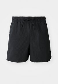 Bañador negro de tela texturizada con cintura elástica, cordón ajustable y bolsillos laterales.