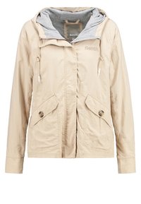 Lysebeige jakke med hætte, der har en grå inderforing, snøre lukning, to frontlommer og knapdetaljer på lommerne.