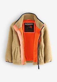 Fleece bunda v béžové barvě s oranžovým podšívkovým lemem, se zipem a kapsami. Má černý límec a kontrastní design uvnitř.