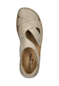 Beige leather sandal with a crisscross design, open heel, and cutouts. Features stitching accents and a cushioned interior. Brand logo visible.