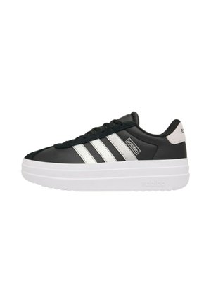 Sneaker nera Adidas con strisce bianche, suola platform spessa bianca, lacci neri e linguetta sul tallone bianca con logo.