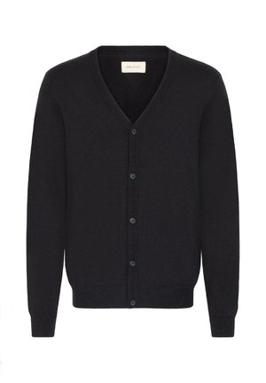 Musta neuletakki, joka on valmistettu pehmeästä neulekankaasta. Siinä on V-pääntie, pitkät hihat ja nappi-etumus, jossa on kuusi pientä nappia.