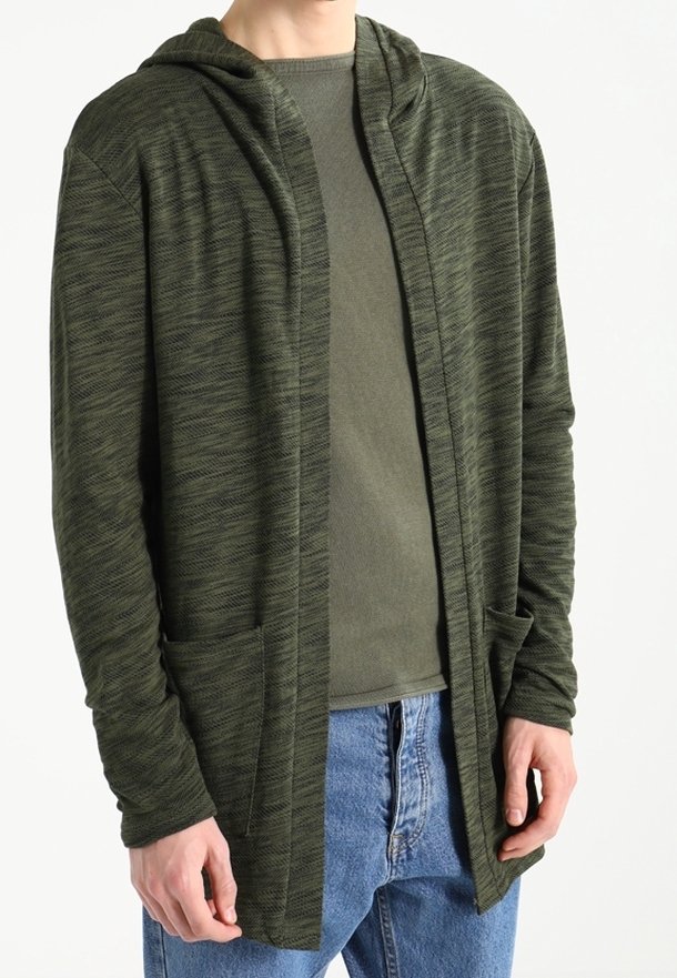 Cardigan lungo aperto in tessuto verde scuro mélange. Presenta un cappuccio, due tasche frontali e polsini a coste. Indossato sopra un top verde chiaro.