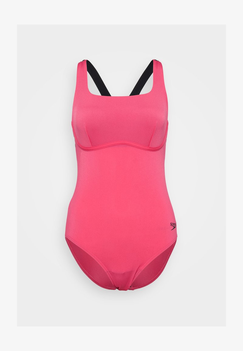 Pink one-piece swimsuit with black straps, featuring a smooth texture, structured cups, and a low-cut back. Brand logo printed on the side.