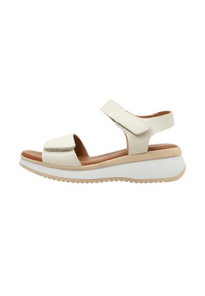 Sandale femme en cuir beige avec brides Velcro réglables, semelle intérieure marron rembourrée et semelle plateforme blanche avec bord beige.