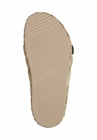 Suola in gomma color tan con linee orizzontali sollevate e superficie testurizzata. Presenta bordi in juta intrecciata, creando un aspetto naturale e organico.