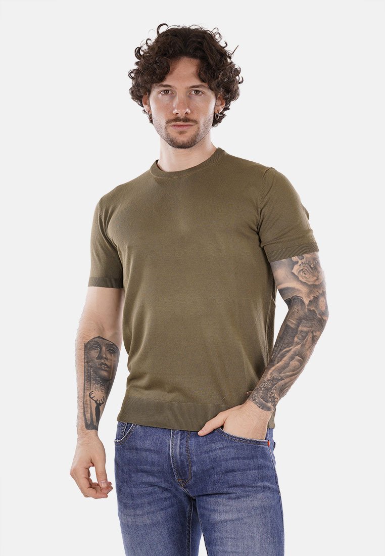 Maglietta a manica corta verde oliva in maglia con colletto e orlo a coste. Tessuto liscio, design aderente, abbinata a jeans in denim blu.