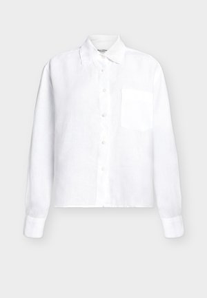 Fehér hosszú ujjú, galléros, gombos ing mellzsebbel, egyszínű minta világos háttéren.