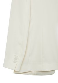 Blazer color crema con una texture liscia, design a un bottone, e tre dettagli con bottoni rivestiti di tessuto sui polsini.