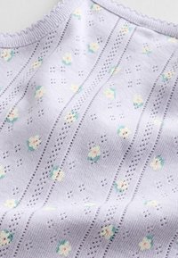 Dzianina z lawendy z małym kremowo-zielonym wzorem kwiatowym i pionowymi ażurowymi pasami.