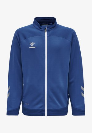 Blaue Polyester-Reißverschlussjacke mit Mesh-Struktur, weißem Reißverschluss und reflektierenden grauen Akzenten an den Schultern. Logo auf der linken Seite.