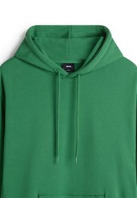 Green hoodie with a kangaroo pocket and drawstring hood, made of soft cotton material, featuring a logo tag on the inside neck.