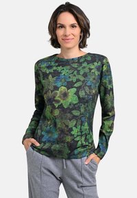 Floral long-sleeve top in dark gray fabric, featuring green and blue flower patterns, round neckline, and a relaxed fit. Grey pants included.