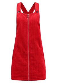 Rotes Corduroy-Latzkleid mit einem vorderen Reißverschluss, breiten Schulterträgern und Seitentaschen. Verfügt über vertikales Rippenmuster für zusätzliche Struktur.