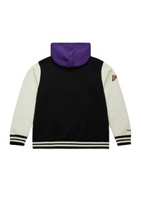 Schwarzer und cremiger Hoodie mit einer lila Kapuze, mit gestreiften Bündchen und Saum sowie einem Logo auf dem linken Ärmel. Glatte Textur, lässiges Design.