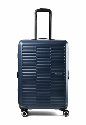 Marineblauer Hartschalenkoffer mit horizontalen Rillen, vier drehbaren Rollen, Teleskopgriff und seitlichen Griffen, Marke American Tourister.