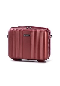 Kosmetická taška v růžovém zlatě s tvrdou skořepinou, vertikálními drážkami, zipovým uzávěrem a černou logo destičkou. Obsahuje rukojeť na nošení a malé nožičky.