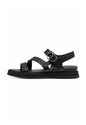 Black sandal featuring wide straps with metal eyelets, a buckle closure, and a flat rubber sole for comfort.