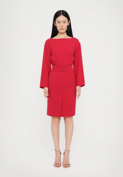 Czerwona sukienka z gładkiego materiału, z szerokim dekoltem, długimi rękawami, elastycznym pasem i krojem sięgającym do kolan. Minimalistyczny design bez wzorów.