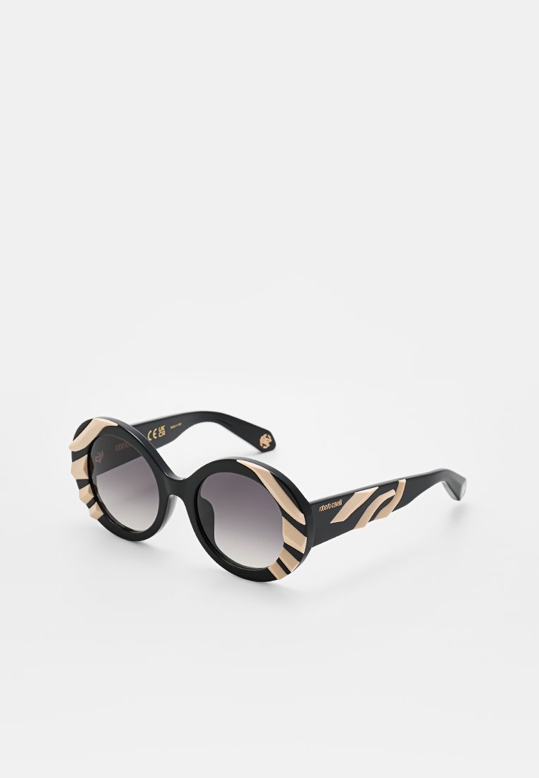 Round sunglasses featuring a black frame with zebra-striped beige accents, gradient grey lenses, and prominent side detailing.