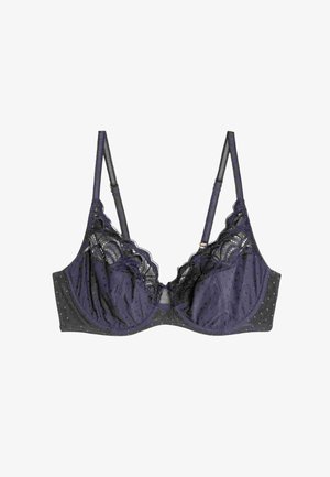Fioletowy biustonosz w kropki z koronkowym wykończeniem. Miękki materiał, wsparcie z fiszbinami, regulowane ramiączka oraz detal w kształcie otworu z przodu.