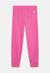 Roze trenirke s elastičnim pojasom i manžetama na gležnjevima. Napravljene od mekanog materijala, s malim bijelim logotipom na prednjoj strani.