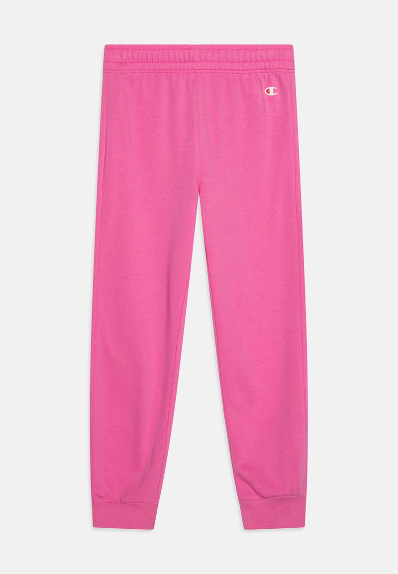 Roze trenirke s elastičnim pojasom i manžetama na gležnjevima. Napravljene od mekanog materijala, s malim bijelim logotipom na prednjoj strani.