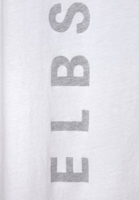 White cotton t-shirt featuring large, light gray block letters spelling "ELBS" oriented vertically on the fabric. Soft texture and casual design.
