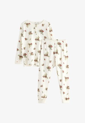 Biała piżama składająca się z topu z długim rękawem i spodni. Oba elementy ozdobione kwiatowym wzorem, zaakcentowanym czerwonymi i zielonymi detalami.