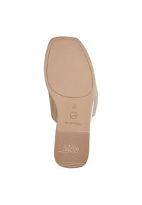 Beige shoe sole with textured grip, rounded toe, and embossed brand logo. Slightly raised heel for added support. Size 37 upper marking.