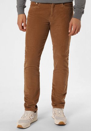 Brown corduroy pants with a straight-leg design feature a textured surface, front pockets, and a zipper fly. Worn with light-colored sneakers.