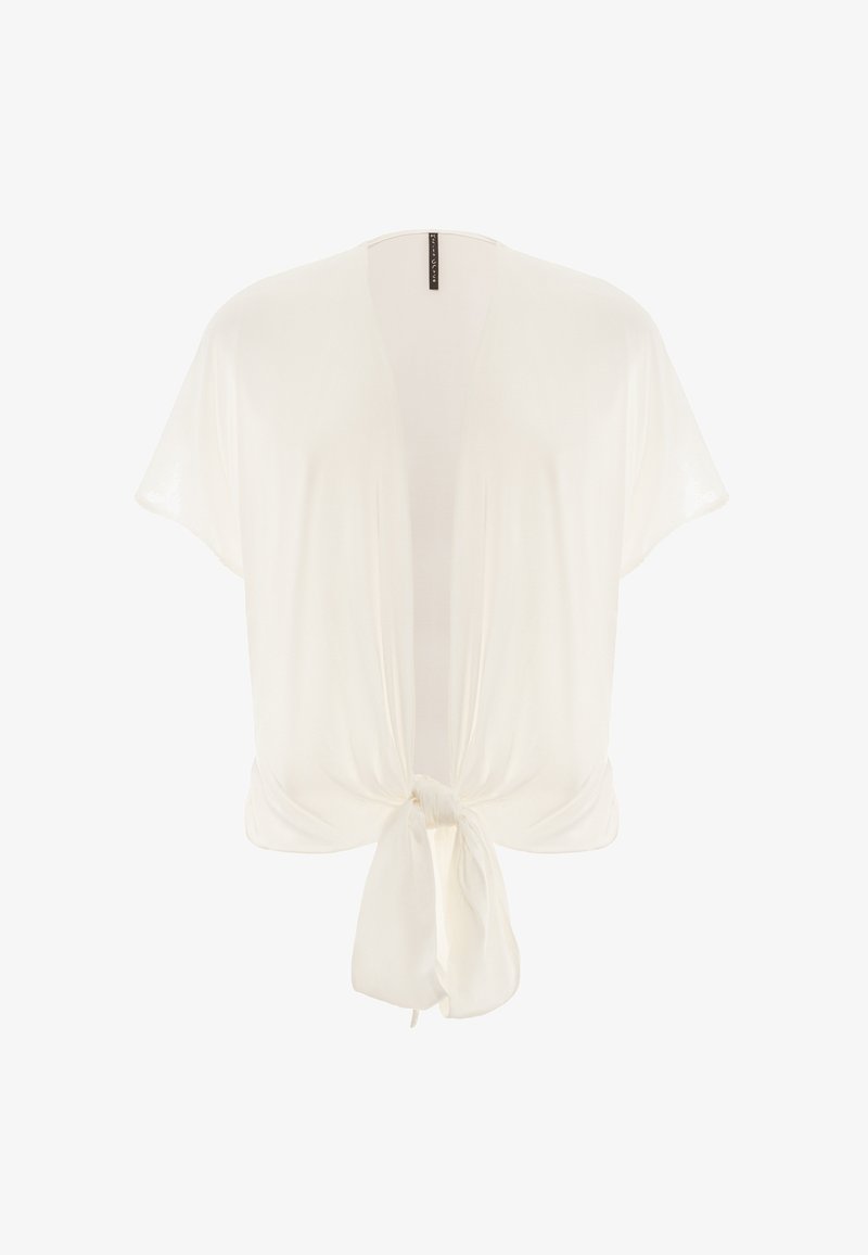 Top bianco leggero con chiusura a fiocco sul davanti, maniche corte e design morbido. Texture liscia con una leggera lucentezza.