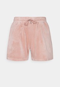 Shorts courts en peluche rose clair avec une ceinture élastique et un cordon de serrage ajustable. Texture douce, longueur mi-cuisse, sans motifs visibles.